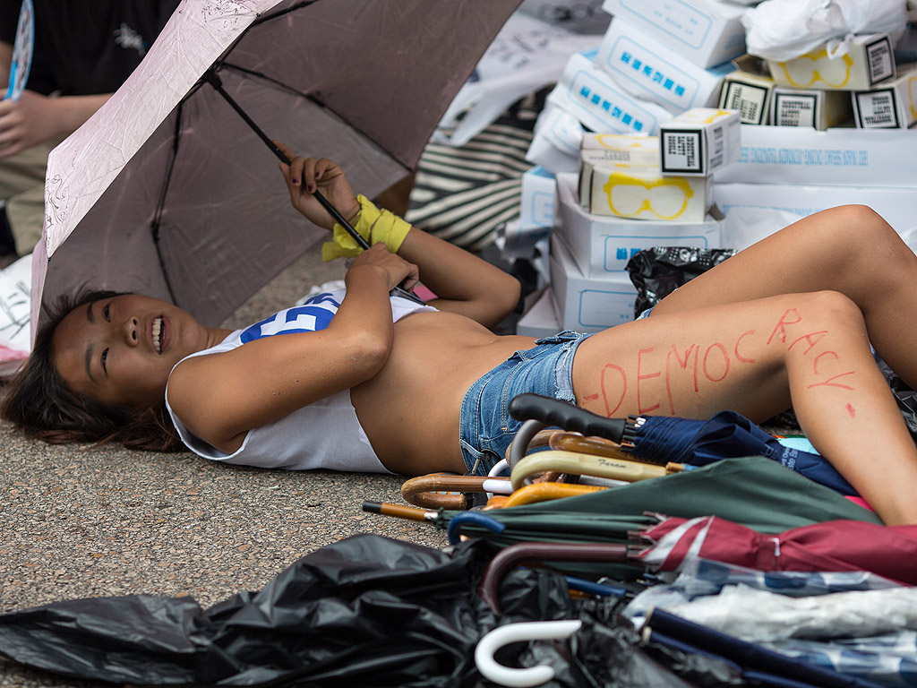 Демонстрант е изписал думата "democracy" върху крака си в Хонг Конг, на четвъртия ден от масовото гражданско неподчинение от кампанията Окупирай Хонг Конг, Китай. Протестиращите продължават да блокират основните транспортни маршрути, след спокойна нощ на демонстрации.