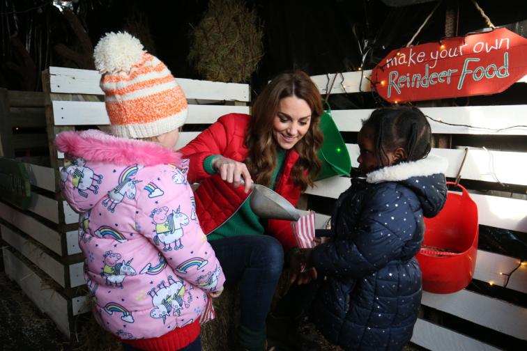  Кейт оказва помощ на деца при избора на елха 