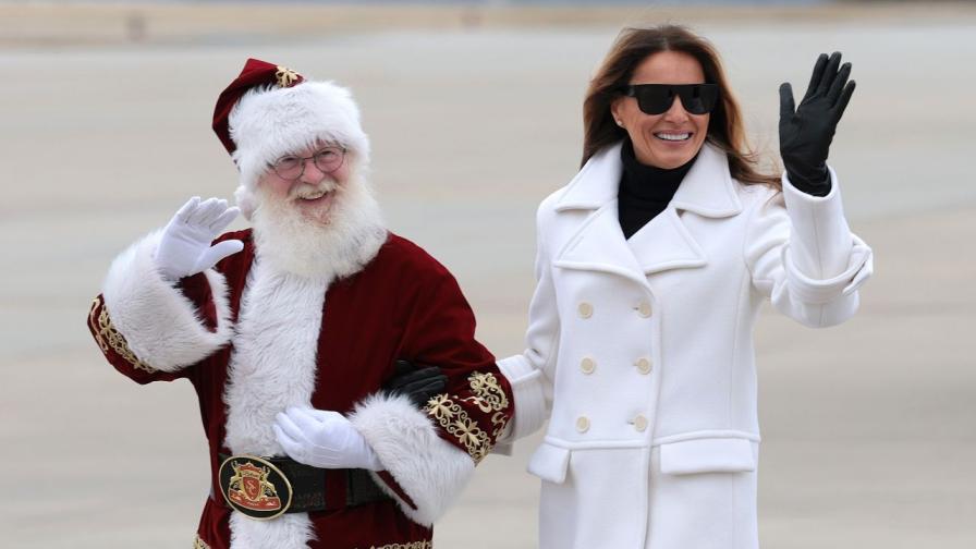 Мелания като стилна Снежанка с черни очила, ръкавици и бяло палто